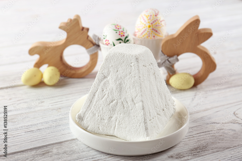 Plate with traditional Easter curd dessert on table