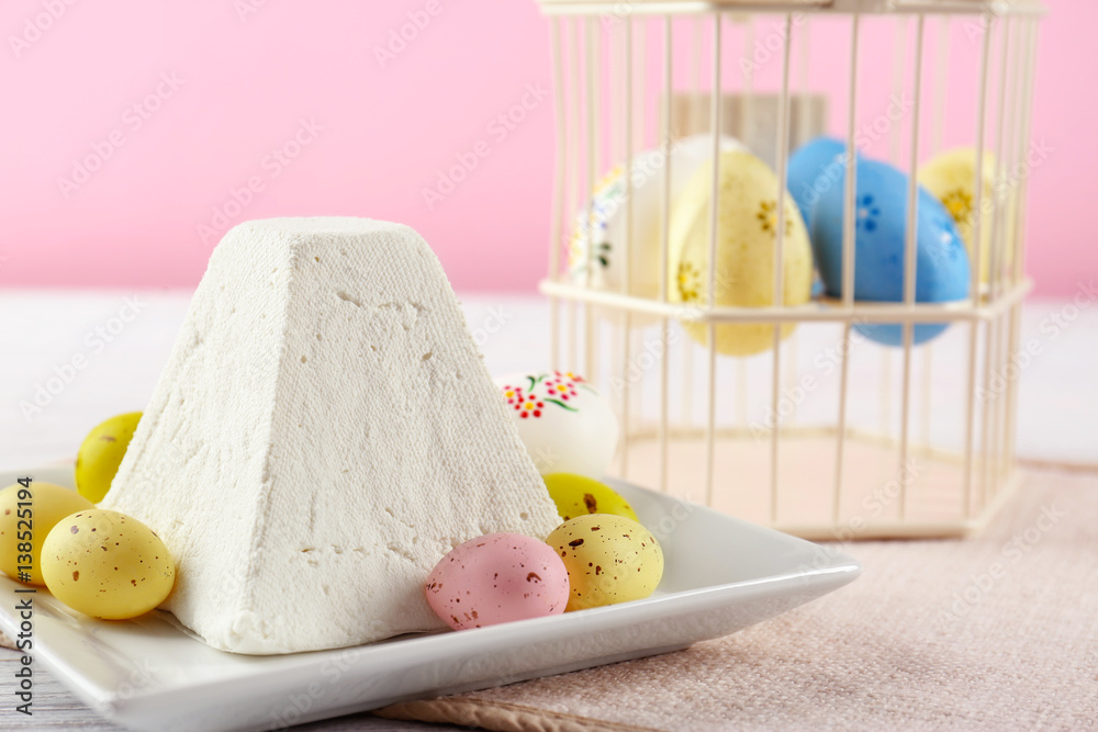 Plate with traditional Easter curd dessert on table