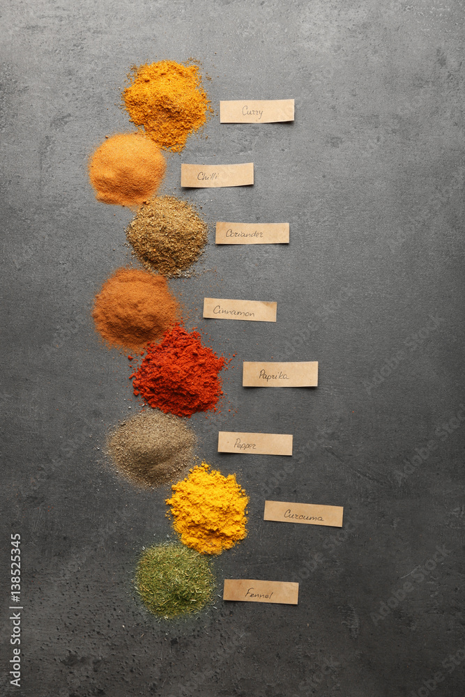 Heaps of various powder spices on table