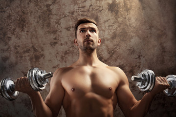 Sticker - Sporty man doing exercises with dumbbells on grunge background