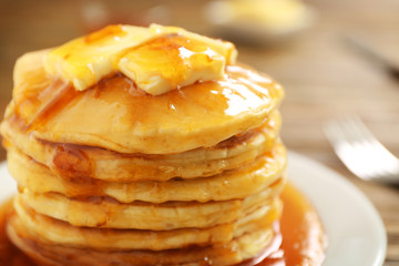 Wall Mural - Delicious pancakes with butter and maple syrup, closeup