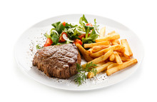 Grilled Steak, French Fries And Vegetables 