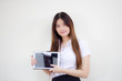 © tiniroma - Portrait of thai adult student university uniform beautiful girl using her tablet.