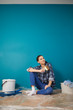 © ZoomTeam - Portrait of female painter near wall before painting.