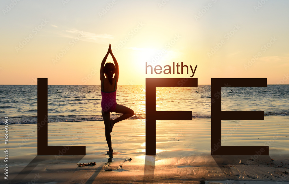 Silhouette of A girl practicing Yoga vrikshasana tree pose on tropical beach with sunset sky background, watching the sunset, standing as a part of the wording concept for healthy life.  - obrazy, fototapety, plakaty 