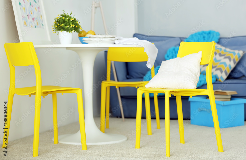Modern room interior with yellow chairs