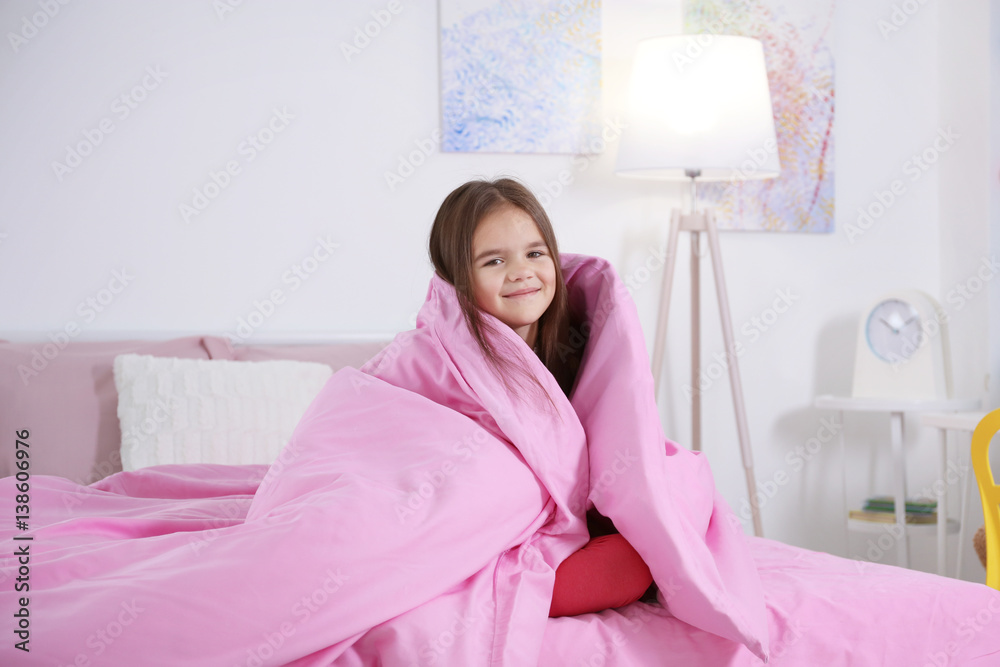 Cute little girl waking up in morning