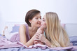 © Africa Studio - Young lesbian couple lying on bed at home