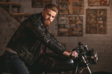 Guy in motorbike repair shop