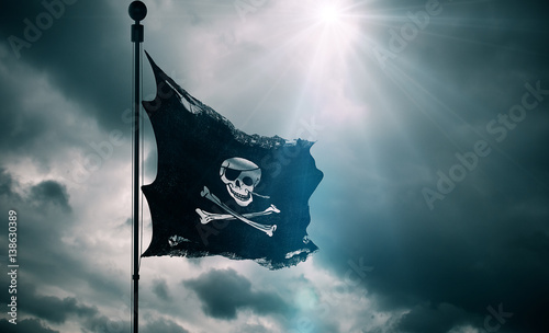 ripped tear grunge old fabric texture of the pirate skull flag waving in wind...