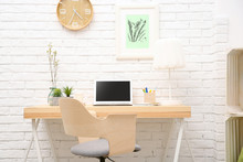 Workplace With Laptop On Desk In Modern Room