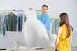 © Africa Studio - Man working with customer in dry-cleaning salon