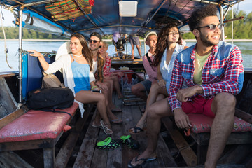Wall Mural - young people group tourist sail long tail thailand boat ocean friends sea vacation travel trip tropi