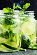 Iced green tea with lime and mint in glass jars, dark background, selective focus