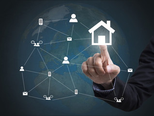 Business hand with home icon networking system. concept globe technology people social network communication.