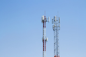 Wall Mural - Mobile phone communication tower transmission  signal with blue sky background and antenna and twin