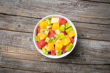 Sticker - Fresh fruit salad on an old wooden background