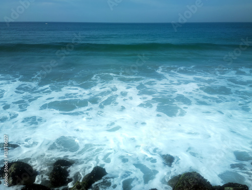 Fotografie, Obraz surf on shores of Indian ocean and overgrown with algae stones