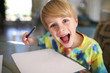 © Christin Lola - Happy Kid with Big Smile Drawing on White Paper with Pen