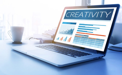 Wall Mural - Creativity text on aptop screen with graph chart background.business marketing,success and goals concept.
