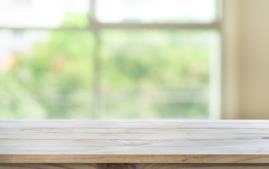 Wall Mural - Empty wood table top on blur abstract green garden from window view in the morning.For montage product display or  key visual layout