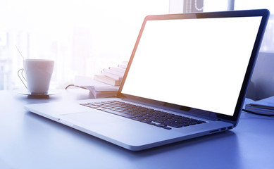 Wall Mural - Light yellow filter effect Laptop with blank screen on desk with big window in modern office.business concept