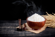 Cooked Rice With Smoke In Wooden Bowl,dark Background