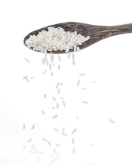 Sticker - dropped rice grain down from a spoon isolated on white background.