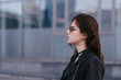 © bodnarphoto - portrait of a beautiful brunette model in glasses, which poses against a background of dark city background