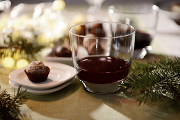 Sticker - Glass of wine and chocolate candy on decorated table closeup