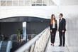 © F8  \ Suport Ukraine - Confident business partners walking down in office building and discussing work