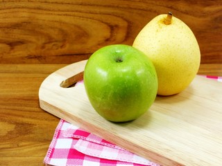 green apple yellow chinese pear on wooden background