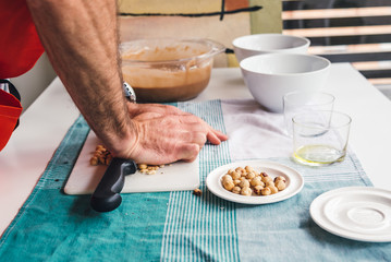 Man preparing a homemade cake with chocolate and hazelnuts