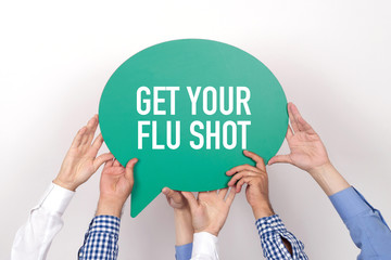 group of people holding the get your flu shot written speech bubble
