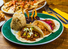 Mexican Tacos Served With Rice And Frijoles