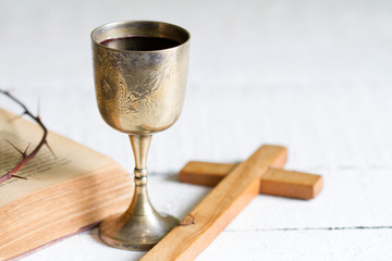 Wall Mural - Cup of wine and cross with bible and thorn easter concept