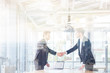 © Drobot Dean - Two happy businessmen standing and shaking hands. Double exposure.