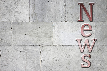 Fototapete - News carved on white stone wall