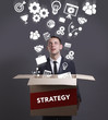 © Egor - Business, Technology, Internet and network concept. Young businessman shows the word: Strategy