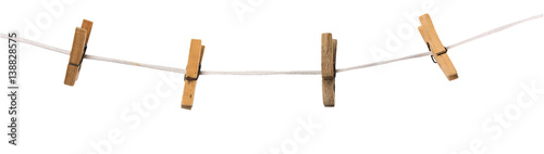 Fotografía Old wooden clothespins on a rope isolated on background