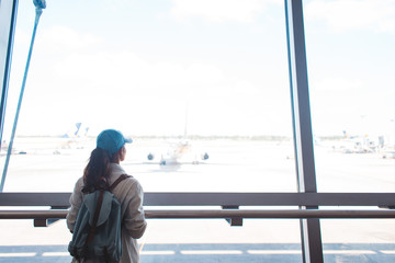 Young woman at airport waiting for airplane