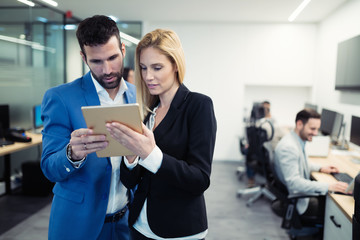 Wall Mural - Business colleagues looking at tablet in office