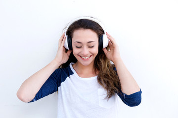 Wall Mural - happy young woman holding headphones and listening to music