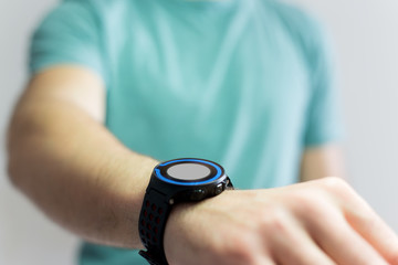 Hand holding black smartwatch with technology screen