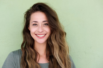 Wall Mural - young happy woman on green background