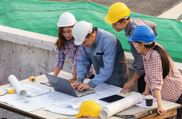 business people group on meeting and presentation with construction engineer architect and worker looking building model and blueprint plans