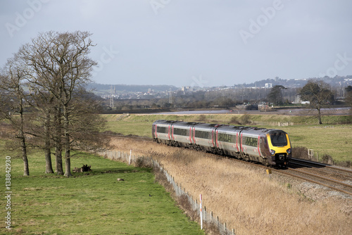 Fotomural A Virgin Trains company passenger train passing through English countryside sout