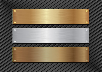Wall Mural - three metal plaques on black background