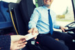 © Syda Productions - close up of bus driver selling ticket to passenger