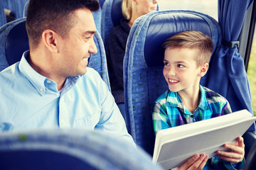 Poster - happy family with tablet pc sitting in travel bus